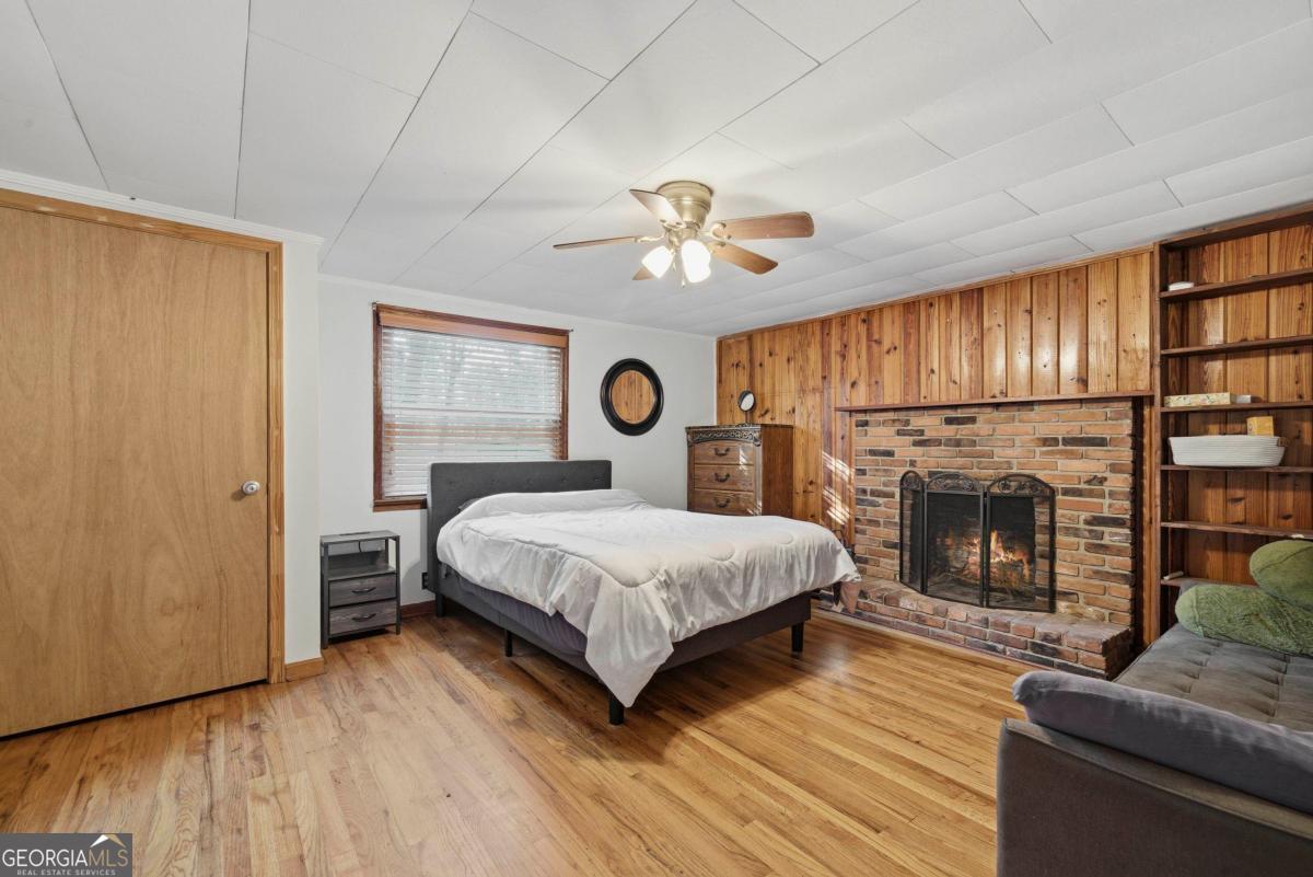 296 Kings Road Milledgeville, GA 31061 - Photo 25 of 36 a bedroom with a bed and a fireplace