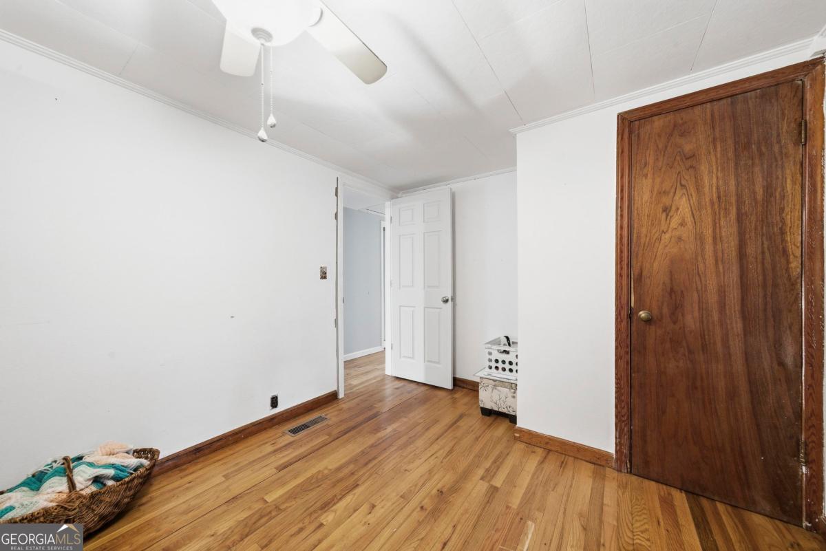 296 Kings Road Milledgeville, GA 31061 - Photo 30 of 36 a view of an empty room with wooden floor