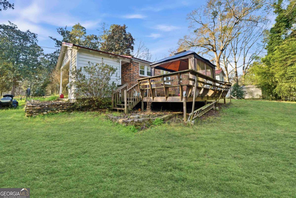 296 Kings Road Milledgeville, GA 31061 - Photo 35 of 36 a wooden house with a big yard and large trees