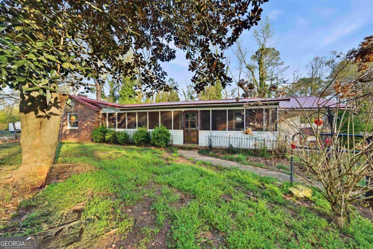 296 Kings Road Milledgeville, GA 31061 - Photo 5 of 36 front view of a house with a yard