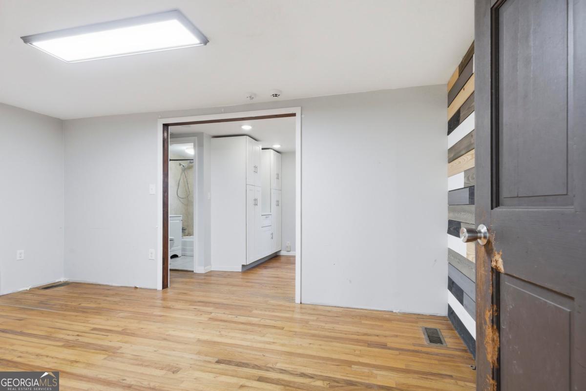 296 Kings Road Milledgeville, GA 31061 - Photo 8 of 36 a view of empty room with wooden floor and fan