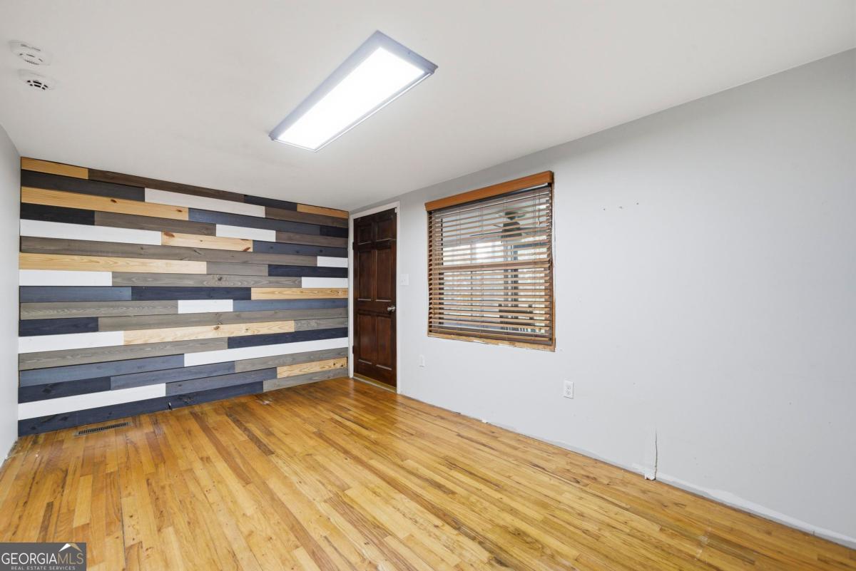 296 Kings Road Milledgeville, GA 31061 - Photo 10 of 36 a view of room with wooden floor and closet