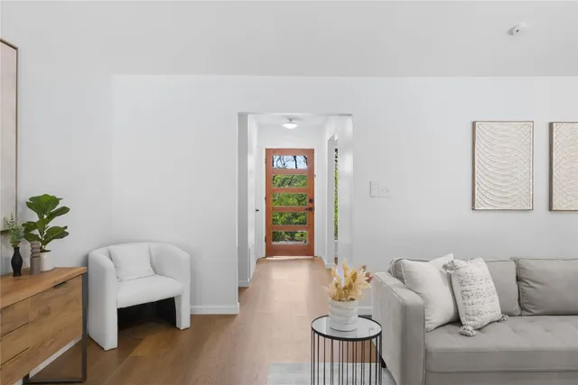 a living room with furniture and a potted plant