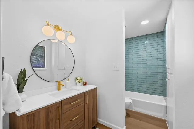 a bathroom with a sink a mirror and a bathtub