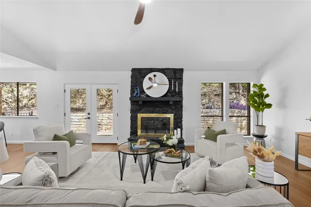 a living room with furniture a fireplace and a potted plant