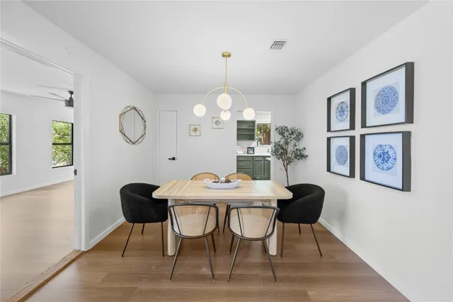 a view of a dining room with furniture and chandelier