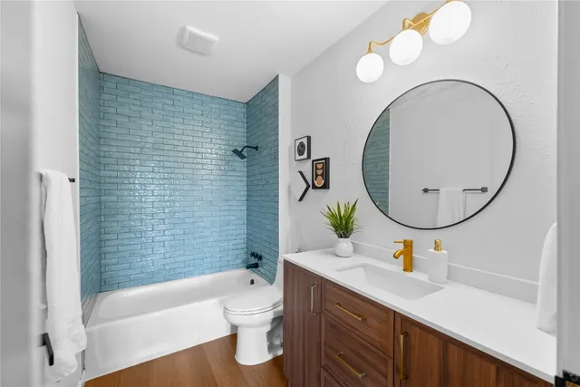 a bathroom with a sink a toilet and a mirror