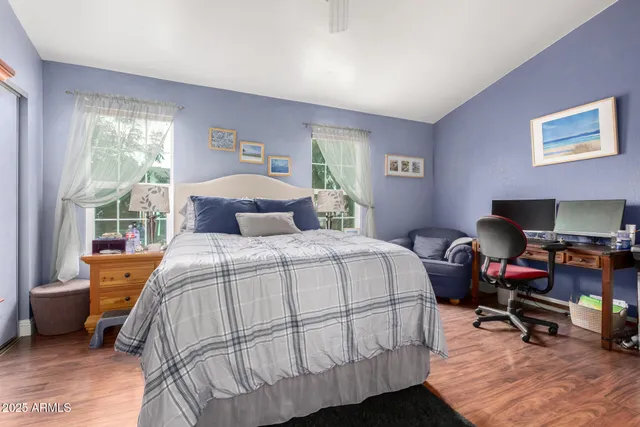 a bedroom with a bed and a chair