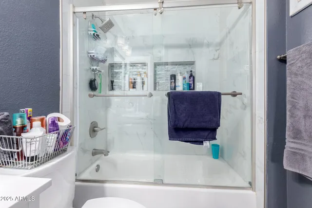 a bathroom with a tub and shower