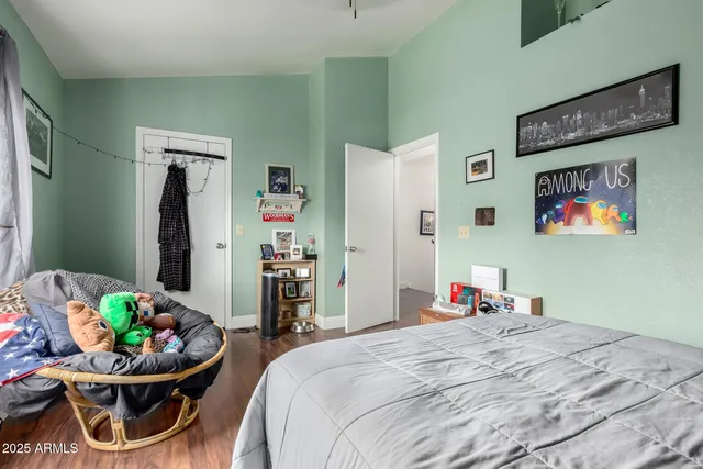 a bed room with a bed and a chair