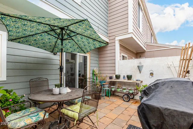 a backyard of a house with table and chairs