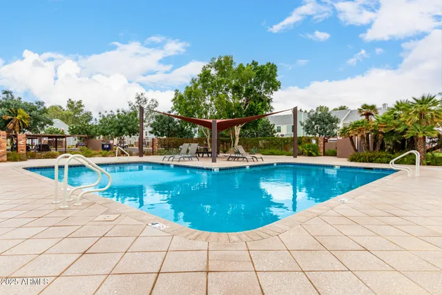 a view of a swimming pool with a lounge chair