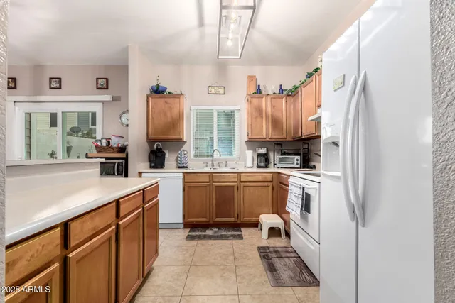 a kitchen with a sink refrigerator and cabinets