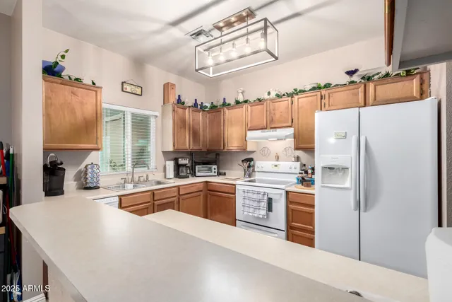a kitchen with stainless steel appliances a refrigerator sink and cabinets