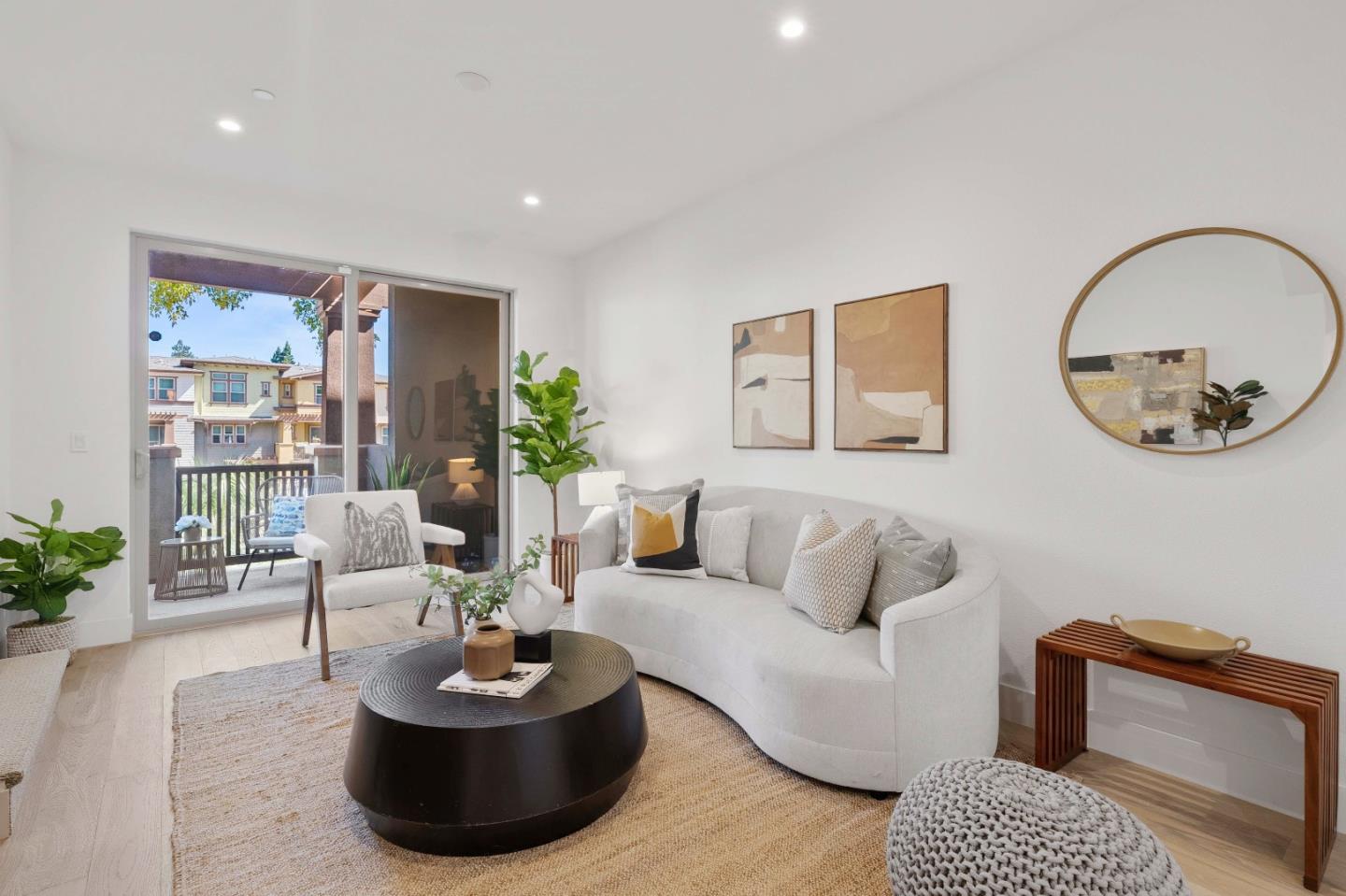 a living room with furniture a lamp and a potted plant