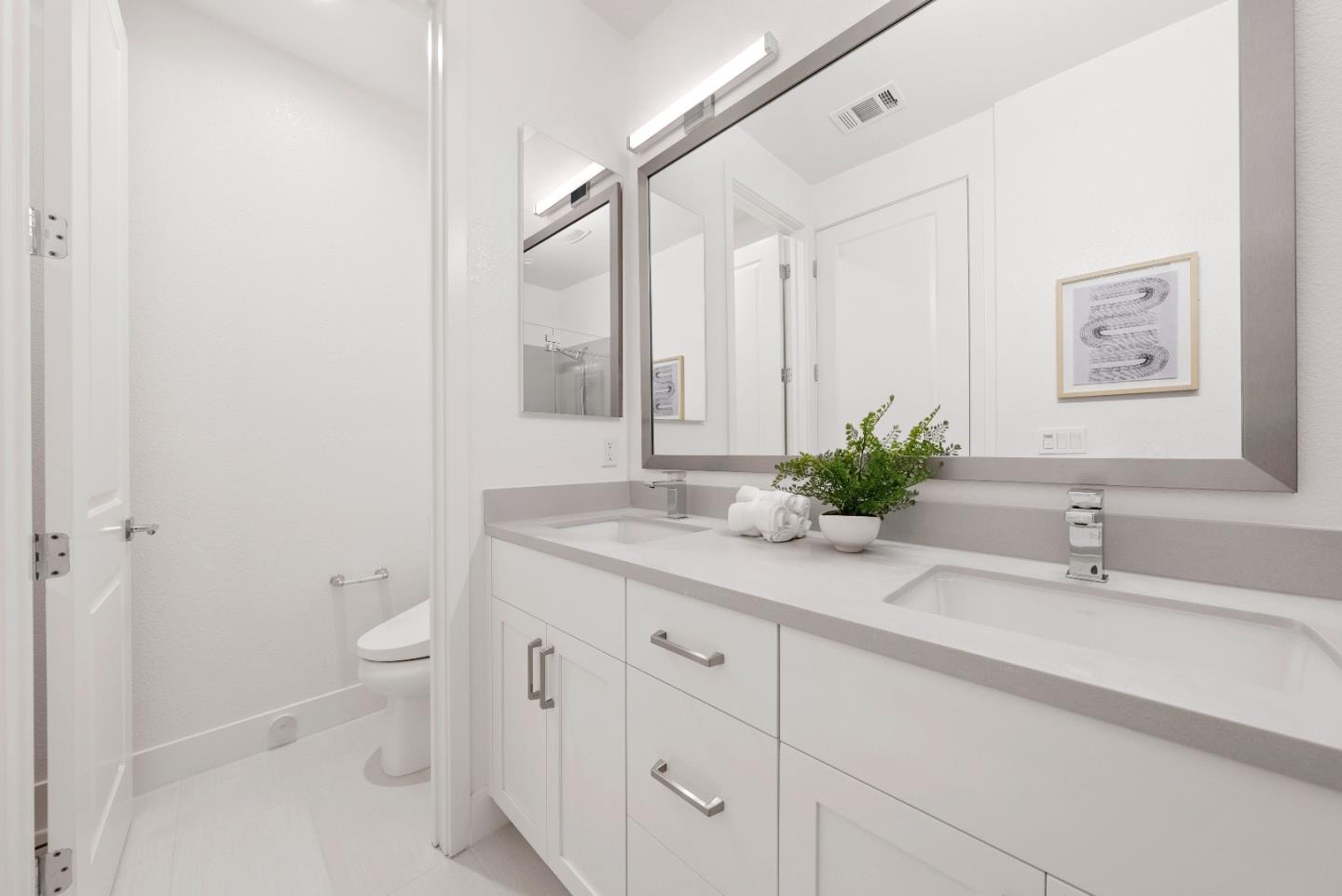 307 Marquetta Circle Mountain View, CA 94043 - Photo 23 of 38 a bathroom with a granite countertop sink a toilet and a large mirror