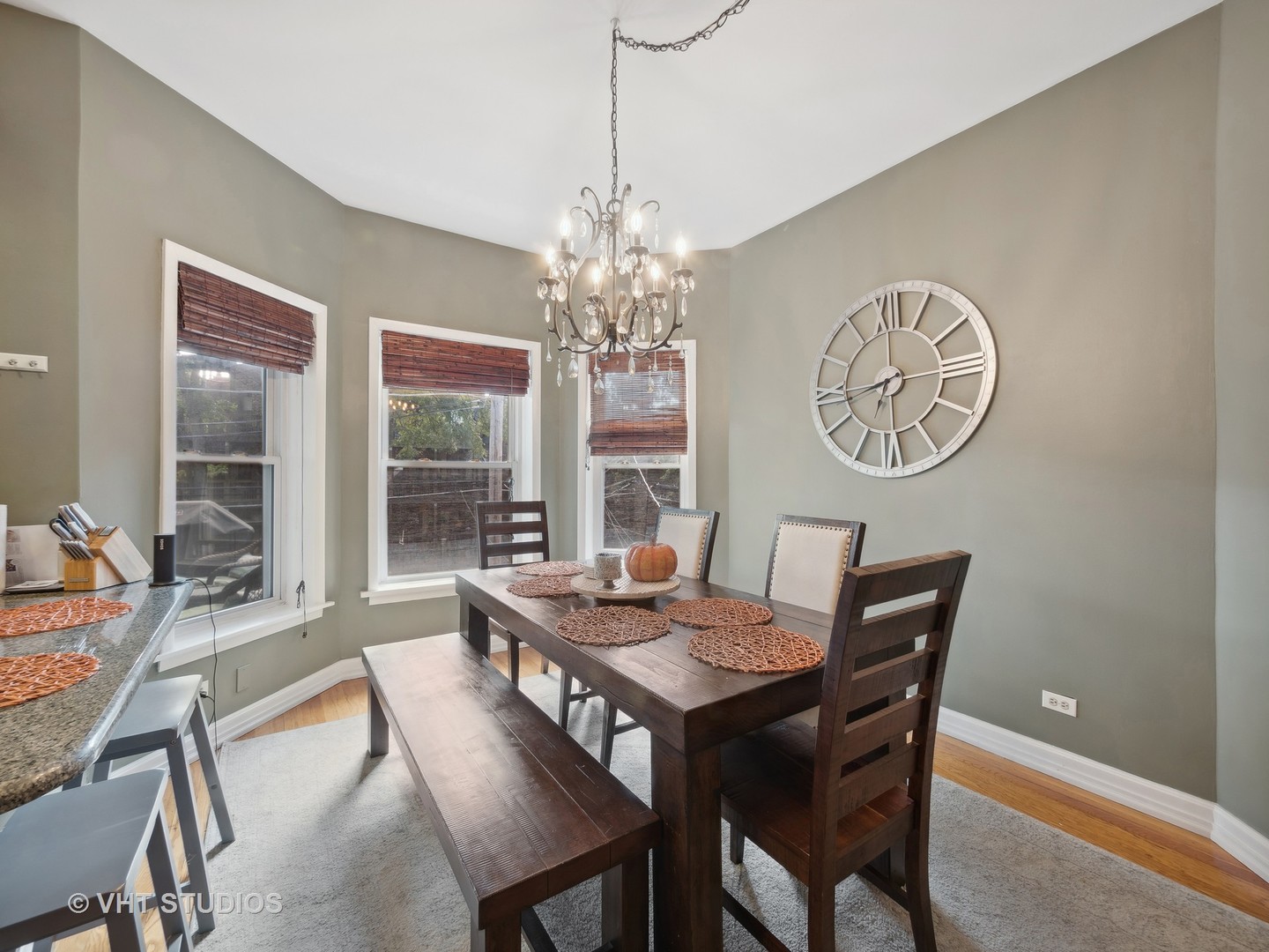 1023 West Dakin Street, Unit 2W Chicago, IL 60613 - Photo 5 of 10 a dining room with furniture a rug and a chandelier