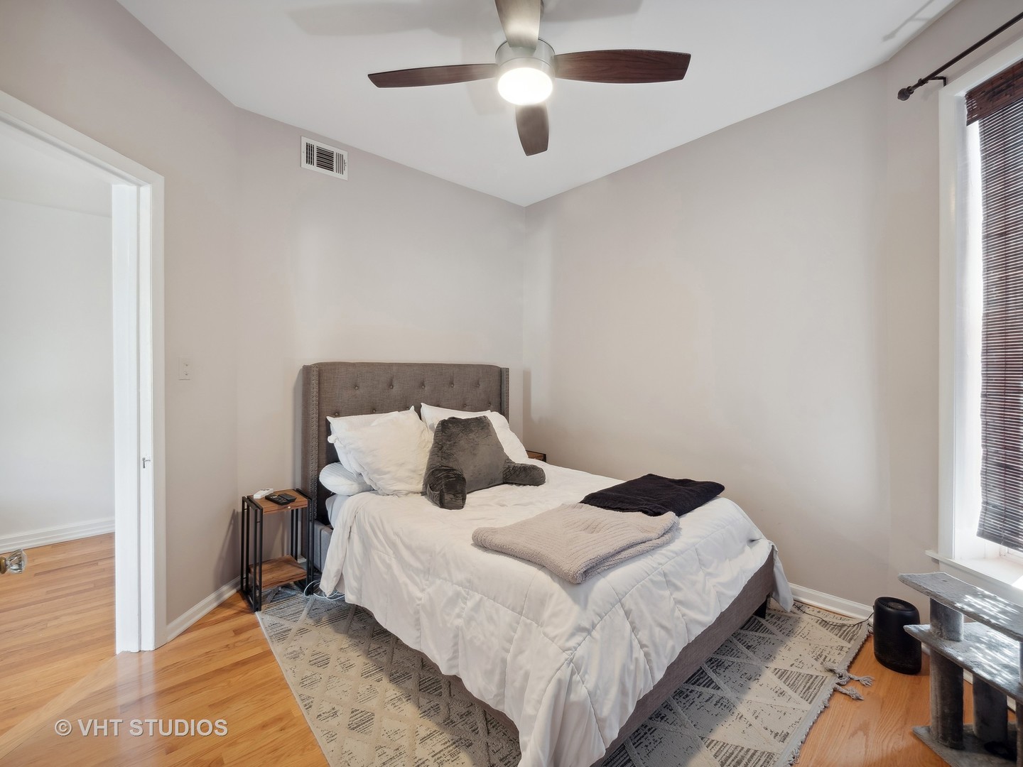 1023 West Dakin Street, Unit 2W Chicago, IL 60613 - Photo 7 of 10 a bedroom with a bed and a chandelier
