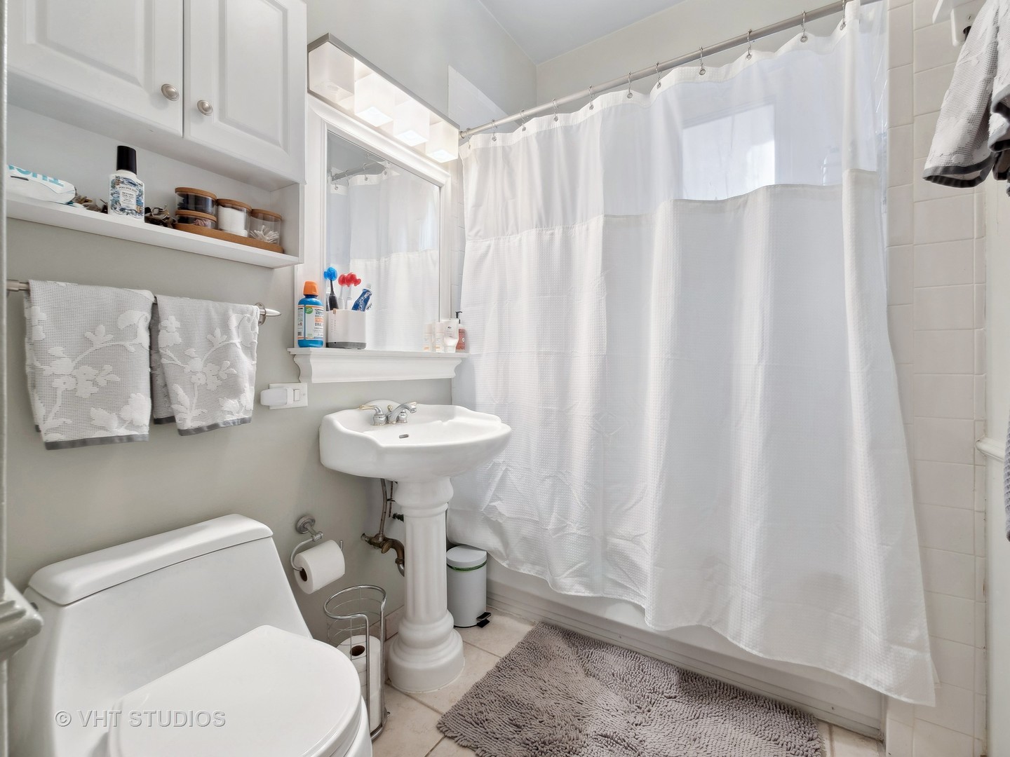 1023 West Dakin Street, Unit 2W Chicago, IL 60613 - Photo 8 of 10 a bathroom with a sink toilet and shower