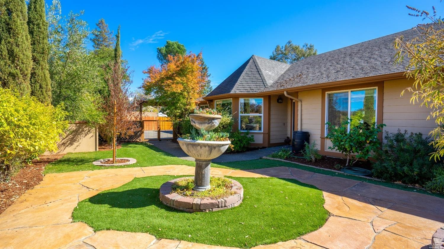 960 Gumview Road Windsor, CA 95492 - Photo 1 of 1 a front view of a house with a yard and fountain