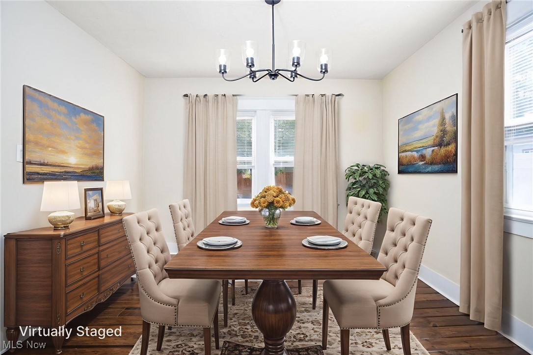 555 Brittain Road Akron, OH 44305 - Photo 6 of 26 Dining area with dark wood-style floors, healthy amount of natural light, and a chandelier