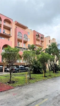 a front view of a building with tree s