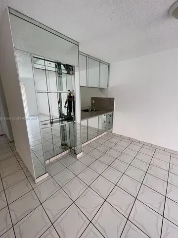 a room with a washing machine and a shower