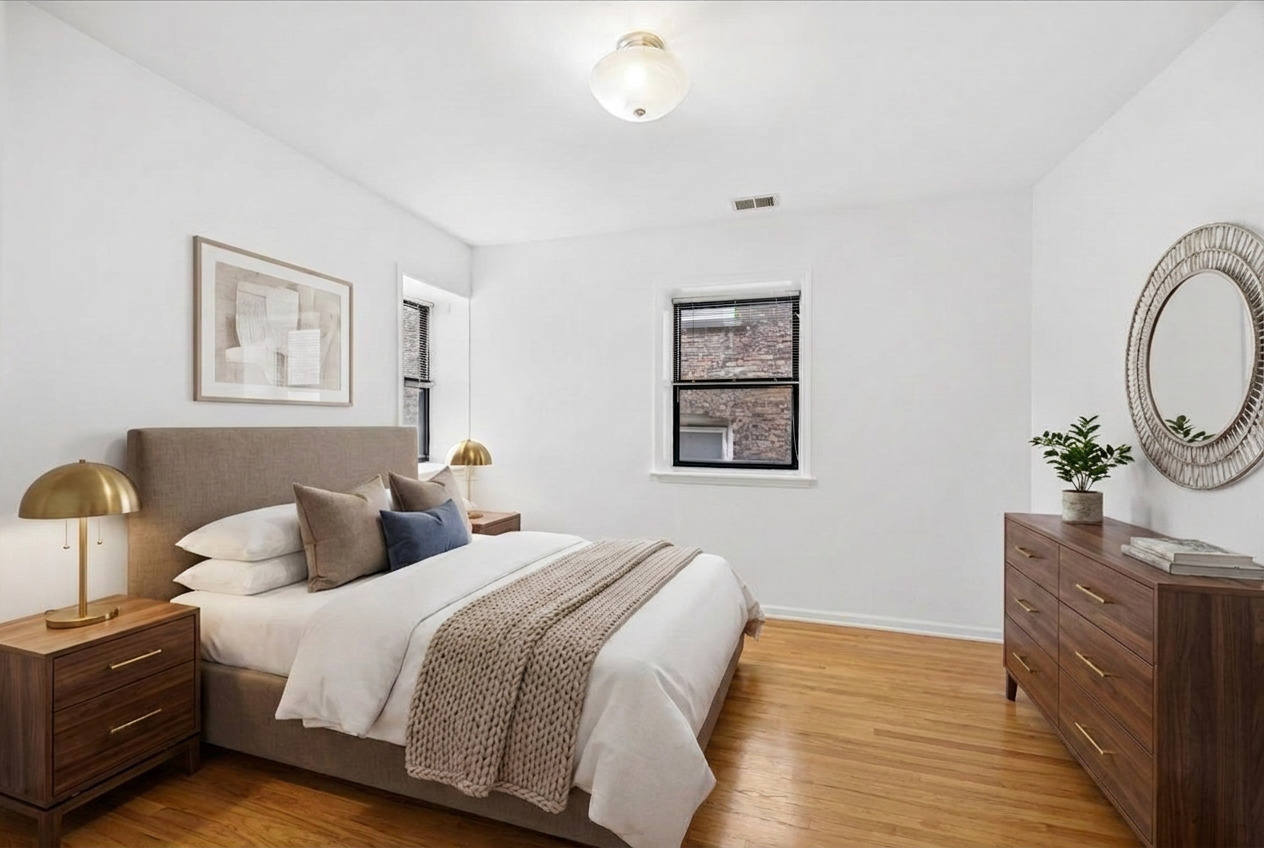 2363 East 70th Street, Unit 1 Chicago, IL 60649 - Photo 10 of 26 a bedroom with bed and a chandelier