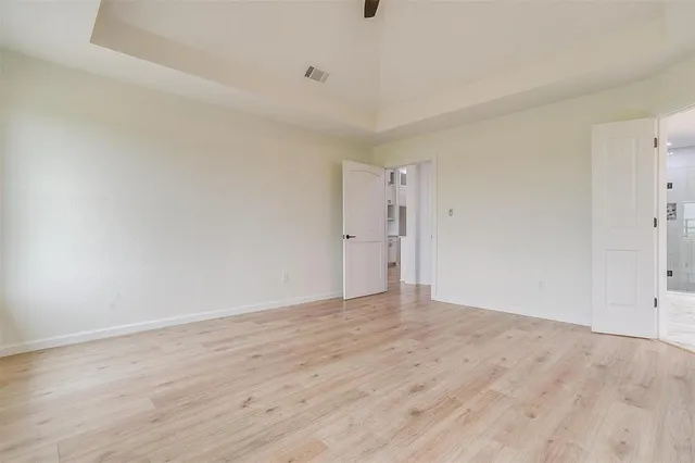 a view of an empty room and wooden floor