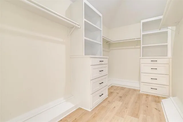 walk in closet with clothes