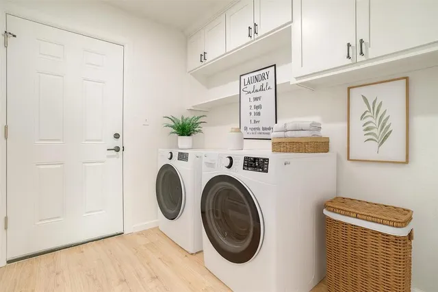 a view of a storage and utility room with washer and dryer