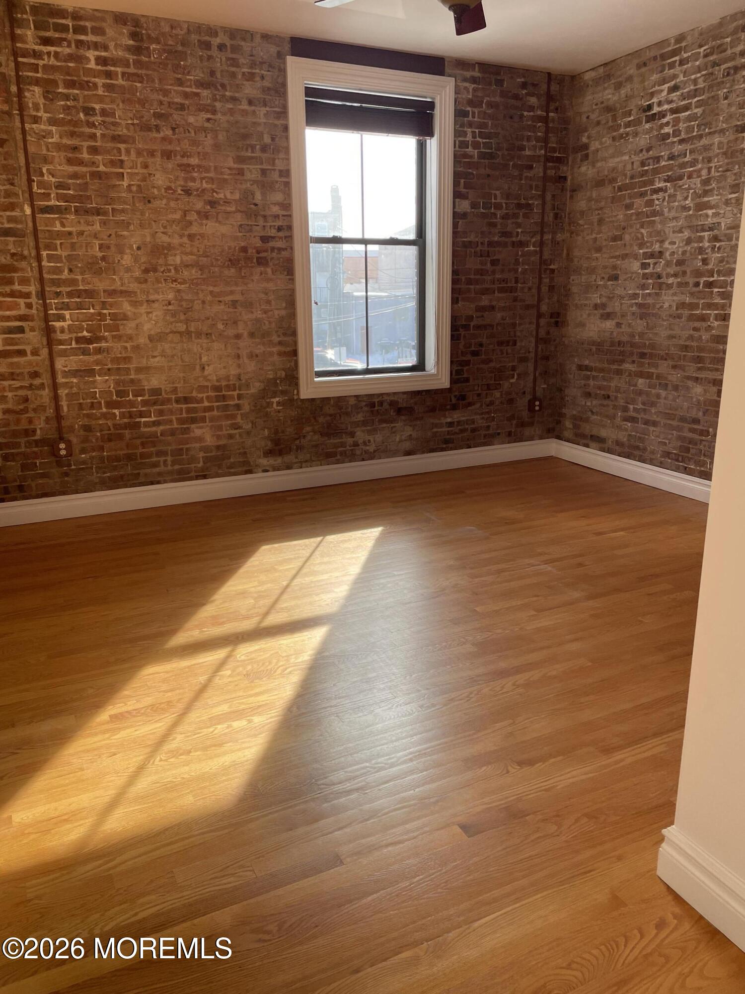 8 East Front Street, Unit 204 Red Bank, NJ 07701 - Photo 3 of 15 a view of empty room with window