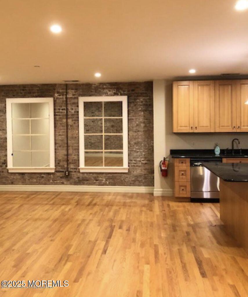 8 East Front Street, Unit 204 Red Bank, NJ 07701 - Photo 6 of 13 a view of a kitchen with granite countertop a sink and a granite counter top