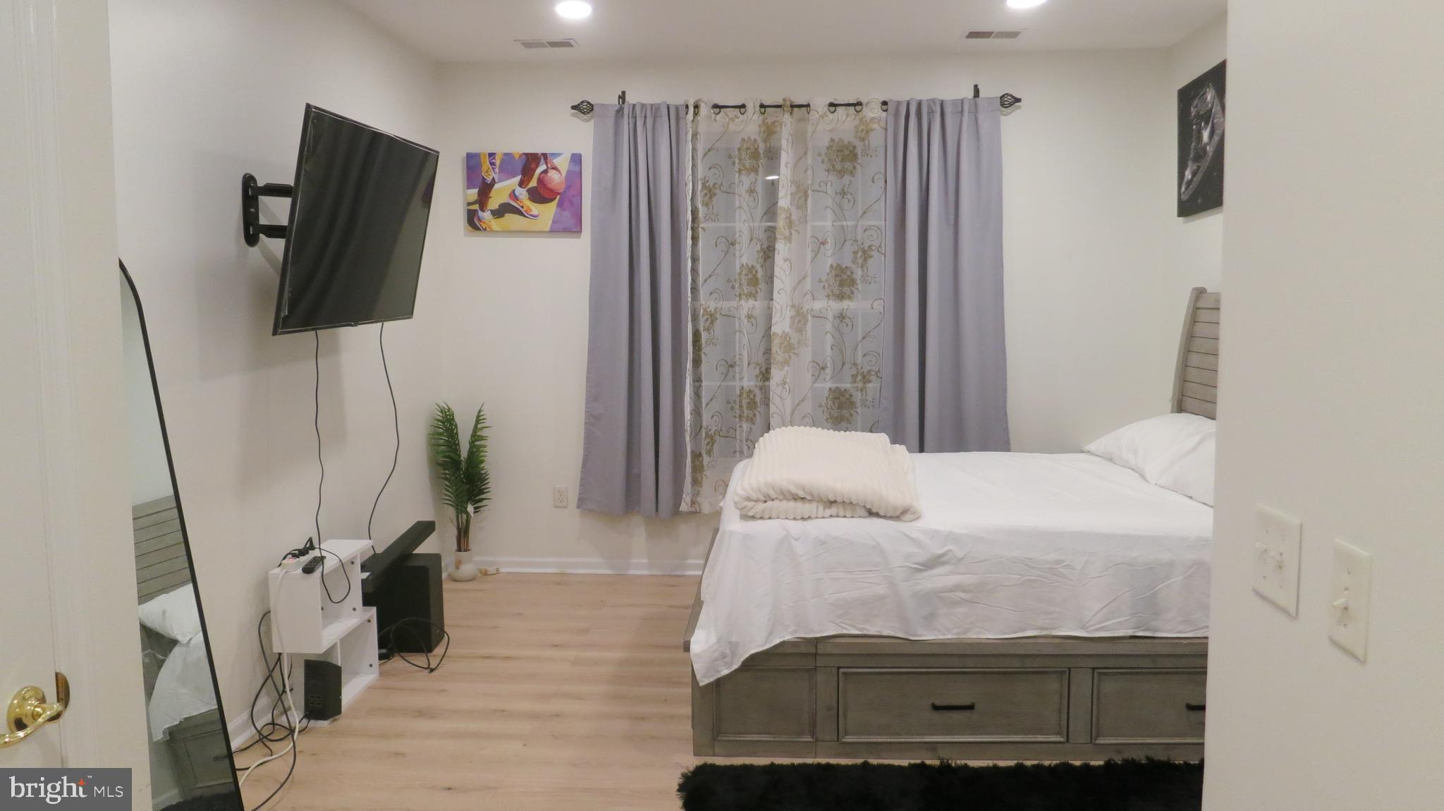 121 Kyle Way Ewing, NJ 08628 - Photo 12 of 25 a bedroom with a bed and a flat tv screen