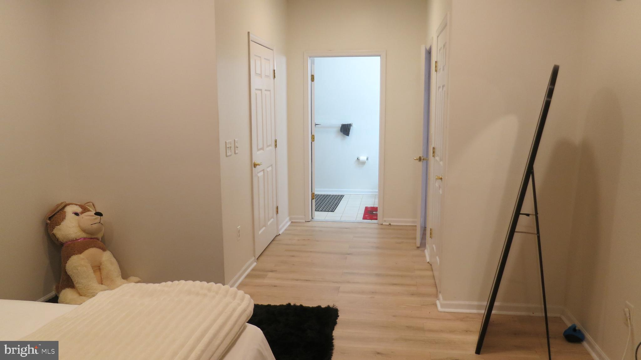 121 Kyle Way Ewing, NJ 08628 - Photo 13 of 25 a bedroom with a bed and wooden floor