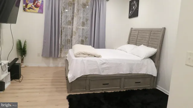 a bedroom with a bed and a window