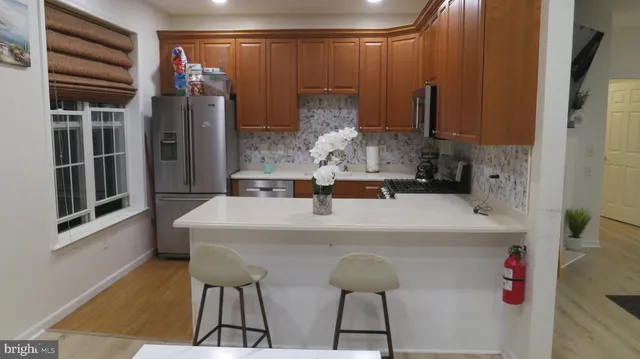 a kitchen with a refrigerator and a table