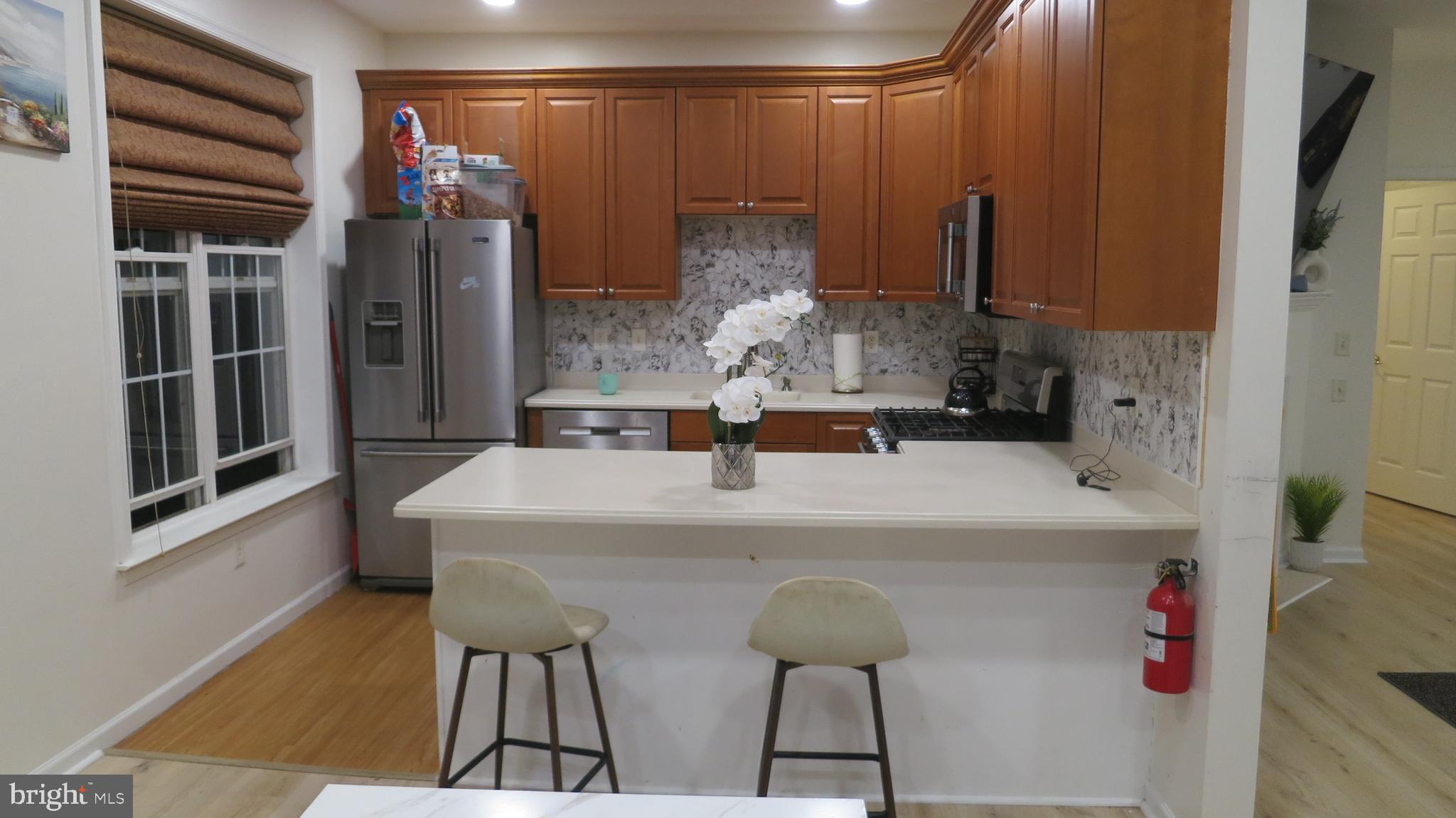 121 Kyle Way Ewing, NJ 08628 - Photo 8 of 25 a kitchen with a refrigerator and a table