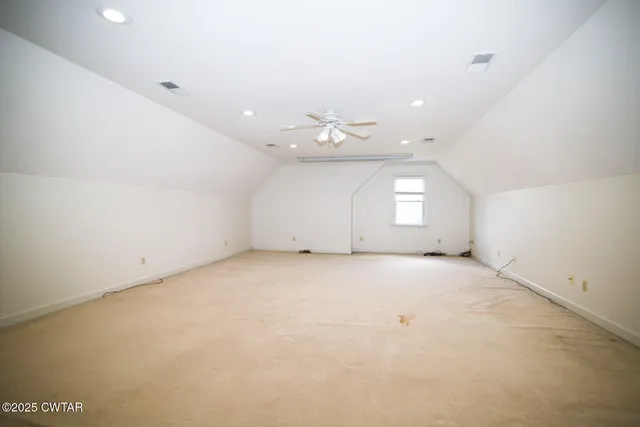 an empty room with a empty space and windows