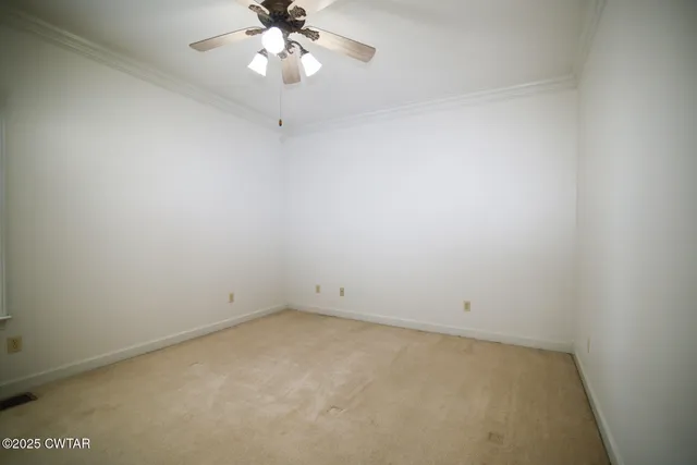 an empty room with a chandelier fan and closet area