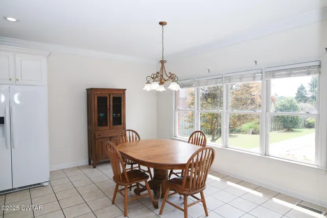a dining room with furniture chandelier