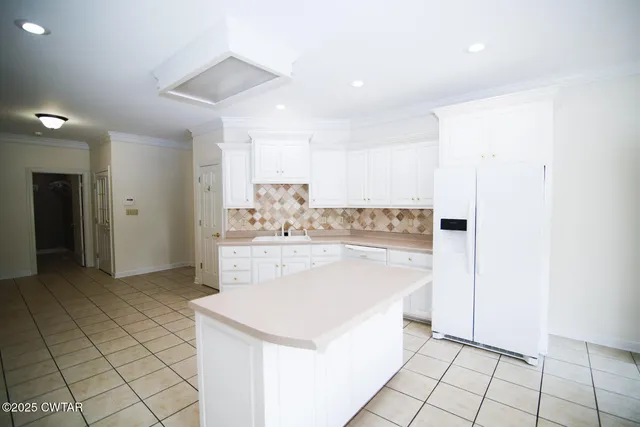 a view of open kitchen with center island and stainless steel appliances
