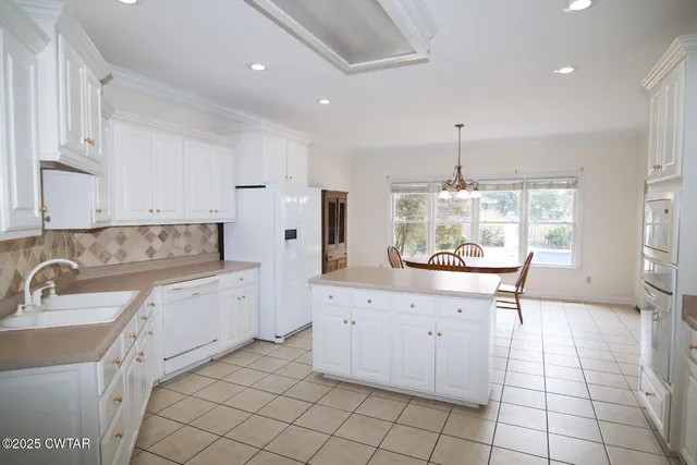 a kitchen with cabinets and chairs