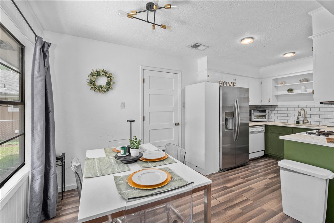 3511 Pecos Court Bryan, TX 77801 - Photo 9 of 22 a kitchen with refrigerator and wooden floor
