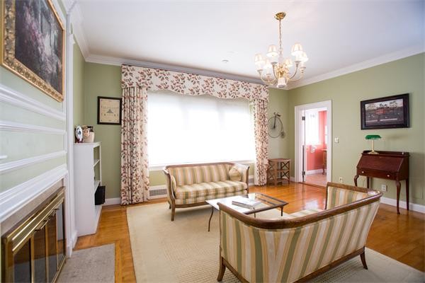 99 Westcliff Road Weston, MA 02493 - Photo 17 of 29 a living room with a couch and a chandelier