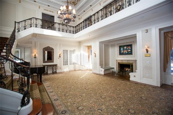 99 Westcliff Road Weston, MA 02493 - Photo 6 of 29 a view of a livingroom with a fireplace a chandelier and windows