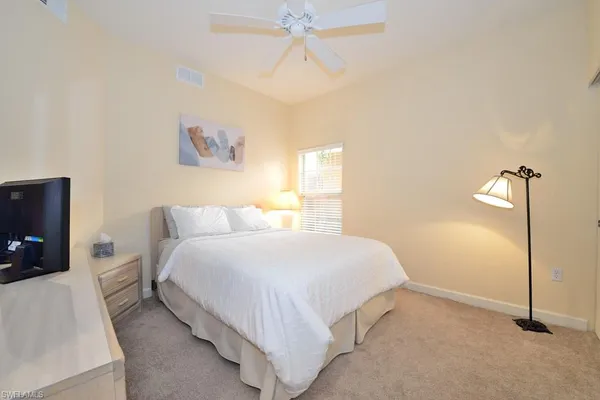 a bedroom with a bed and a tv