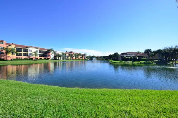 a view of a lake with houses in the background