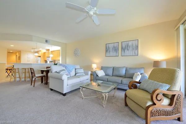 a living room with furniture and a lamp