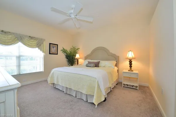 a bedroom with bed and a window